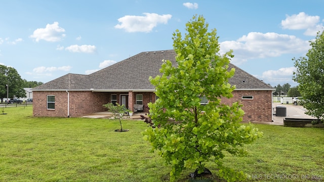 21 E 171st St S, Glenpool, OK 74033 - back of property featuring a patio area, brick siding, a shingled roof, and central air condition unit