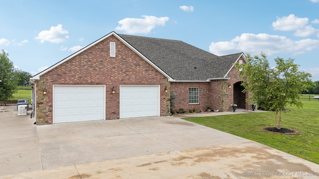21 E 171st St S, Glenpool, OK 74033 - traditional-style home featuring driveway, a front lawn, a garage, roof with shingles, and brick siding
