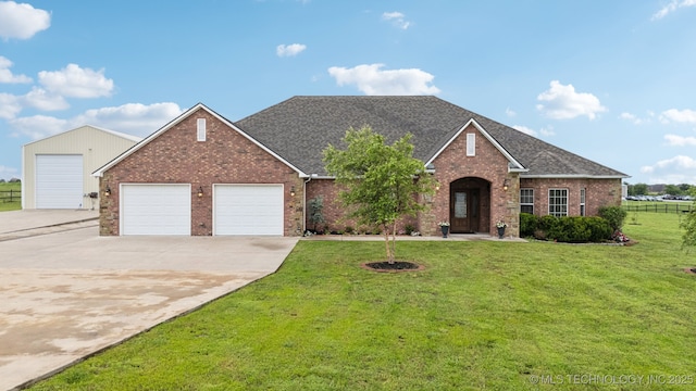 21 E 171st St S, Glenpool, OK 74033 - traditional home with brick siding, a garage, concrete driveway, and a shingled roof