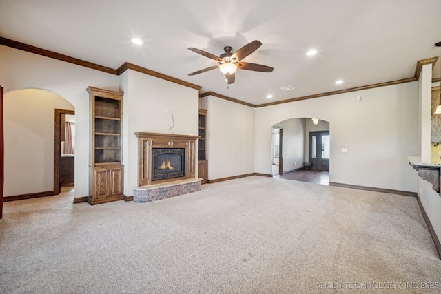 21 E 171st St S, Glenpool, OK 74033 - unfurnished living room featuring arched walkways, recessed lighting, a ceiling fan, carpet flooring, and a fireplace