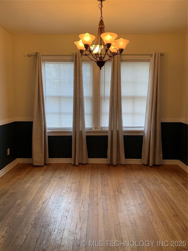 141 N College Ave, Tulsa, OK 74110 - unfurnished room featuring a chandelier and wood-type flooring