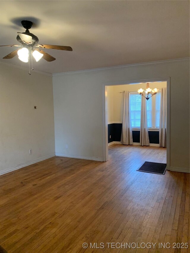 141 N College Ave, Tulsa, OK 74110 - spare room featuring ornamental molding, hardwood / wood-style floors, a chandelier, and ceiling fan