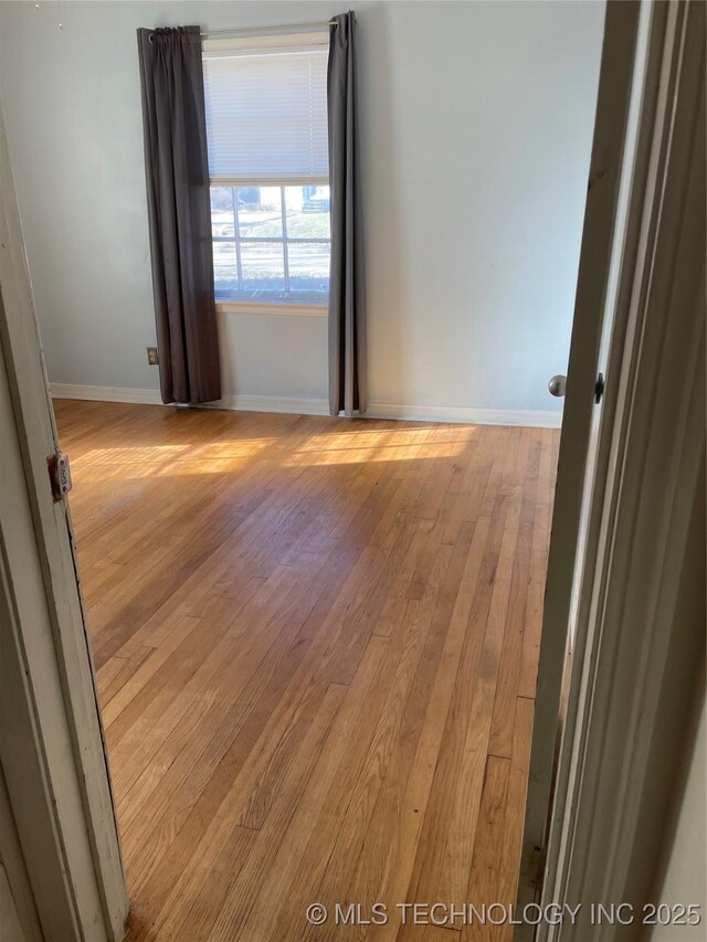 141 N College Ave, Tulsa, OK 74110 - empty room featuring light wood-style floors and baseboards