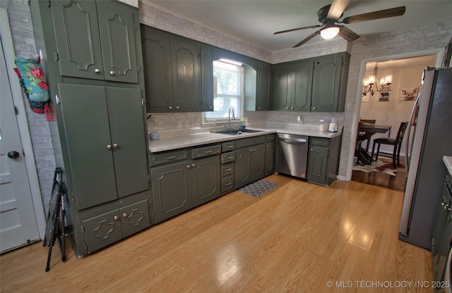 120 S Camden St, Muskogee, OK 74403 - kitchen featuring stainless steel appliances, ceiling fan, a sink, light wood-style flooring, and decorative backsplash