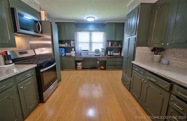 120 S Camden St, Muskogee, OK 74403 - kitchen with appliances with stainless steel finishes, green cabinetry, decorative backsplash, light wood-style flooring, and open shelves