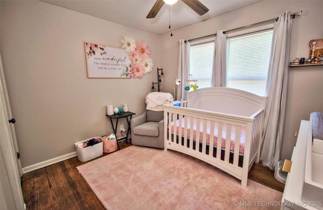 120 S Camden St, Muskogee, OK 74403 - bedroom featuring a crib, wood finished floors, and baseboards