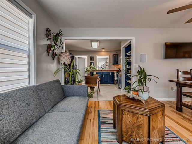 3215 W 41st St, Tulsa, OK 74107 - living area with light wood-type flooring, a ceiling fan, plenty of natural light, and baseboards