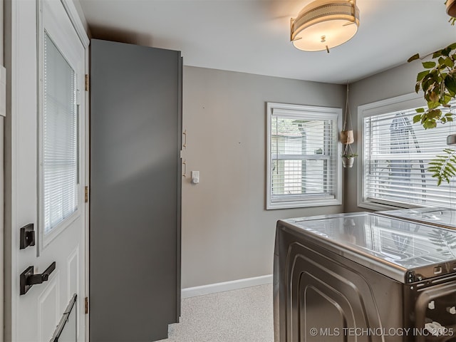 3215 W 41st St, Tulsa, OK 74107 - kitchen with baseboards, washing machine and dryer, and speckle patterned floor