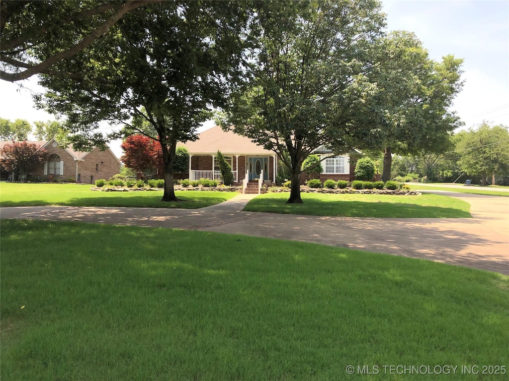 17704 E 92nd St, Owasso, OK 74055 - view of property hidden behind natural elements featuring a front lawn