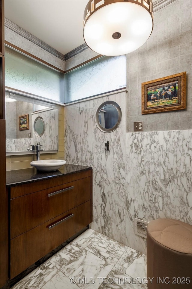 1919 E 30th Pl, Tulsa, OK 74114 - bathroom featuring tile walls, vanity, and marble finish floors
