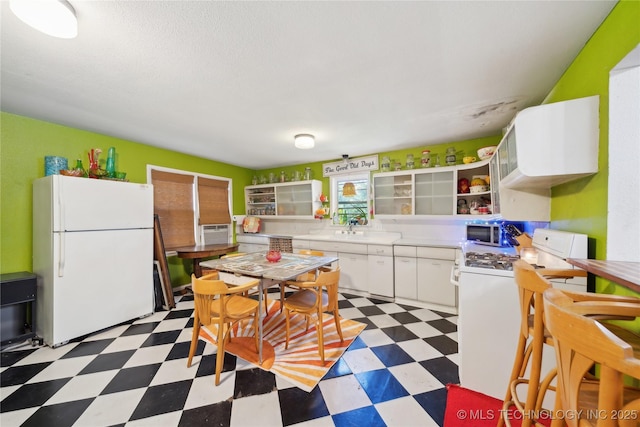 528 S Muskogee, Tahlequah, OK 74464 - kitchen featuring white appliances, light flooring, open shelves, light countertops, and white cabinetry