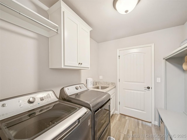12909 S First St, Jenks, OK 74037 - laundry room with washing machine and dryer, cabinet space, and light wood-type flooring
