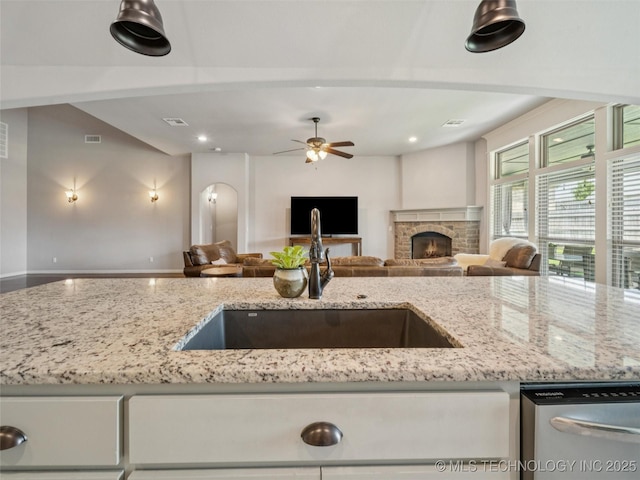 12909 S First St, Jenks, OK 74037 - kitchen featuring dishwasher, a sink, open floor plan, light stone countertops, and recessed lighting