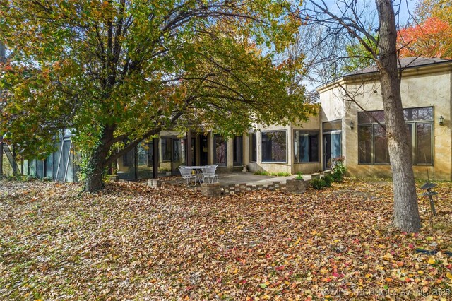 11601 S 193rd E Ave, Broken Arrow, OK 74014 - rear view of house with stucco siding and a patio