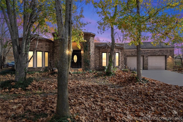 11601 S 193rd E Ave, Broken Arrow, OK 74014 - view of front of property featuring an attached garage, driveway, brick siding, and a tiled roof
