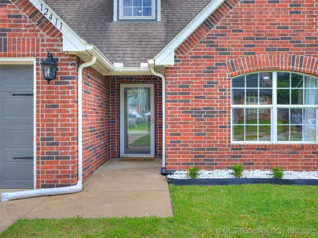 12411 E 90th St N, Owasso, OK 74055 - property entrance featuring brick siding and a shingled roof
