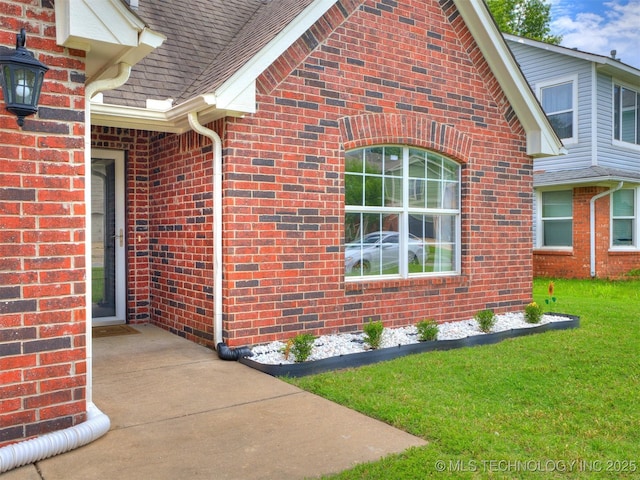 12411 E 90th St N, Owasso, OK 74055 - view of side of home featuring brick siding, a lawn, and roof with shingles