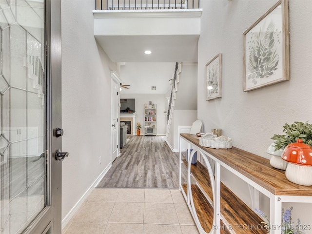 12411 E 90th St N, Owasso, OK 74055 - entrance foyer with a fireplace, light tile patterned flooring, and baseboards