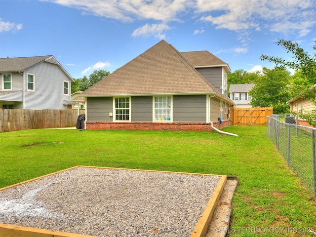 12411 E 90th St N, Owasso, OK 74055 - back of house featuring brick siding and roof with shingles