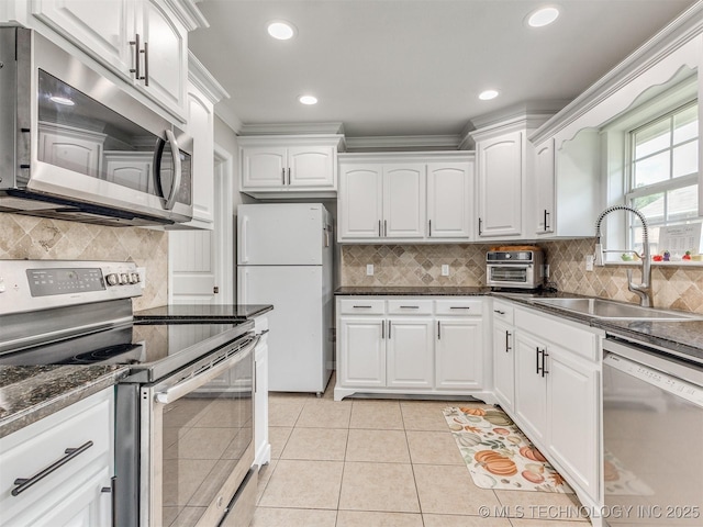 12411 E 90th St N, Owasso, OK 74055 - kitchen with stainless steel appliances, a sink, white cabinets, decorative backsplash, and recessed lighting