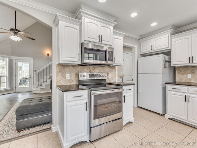 12411 E 90th St N, Owasso, OK 74055 - kitchen with stainless steel appliances, ornamental molding, ceiling fan, tasteful backsplash, and white cabinets