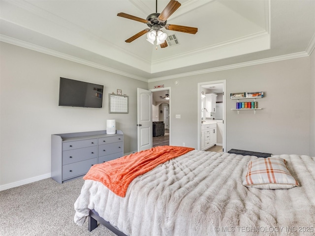 12411 E 90th St N, Owasso, OK 74055 - bedroom with a tray ceiling, ornamental molding, carpet, baseboards, and connected bathroom