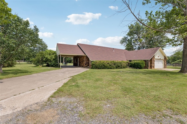 242 Weatherman St, Kellyville, OK 74039 - view of front of house featuring a front lawn, a garage, driveway, board and batten siding, and an attached carport