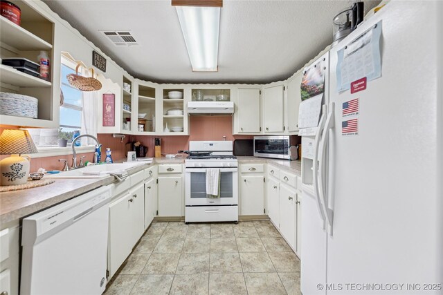 242 Weatherman St, Kellyville, OK 74039 - kitchen with white appliances, under cabinet range hood, light countertops, and a sink