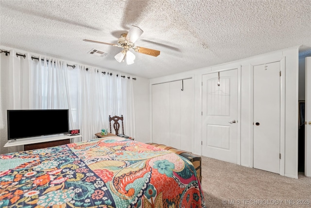 242 Weatherman St, Kellyville, OK 74039 - bedroom with two closets, carpet, a textured ceiling, and a ceiling fan