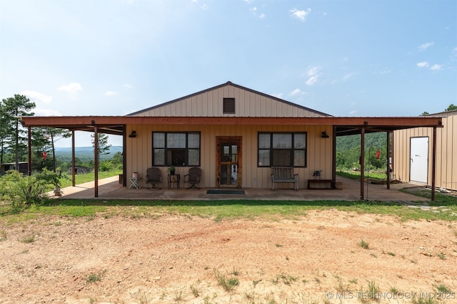 3819 129th Rd, Panola, OK 74559 - rear view of house with board and batten siding