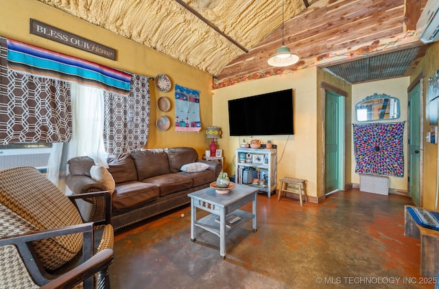 3819 129th Rd, Panola, OK 74559 - living area featuring concrete flooring, lofted ceiling, and a wall mounted air conditioner