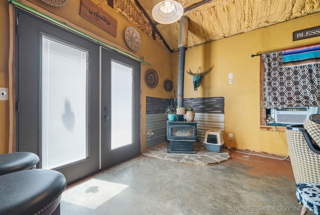 3819 129th Rd, Panola, OK 74559 - living area with a wood stove, french doors, and concrete floors