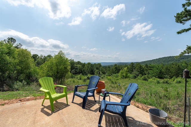 3819 129th Rd, Panola, OK 74559 - view of patio / terrace featuring a wooded view