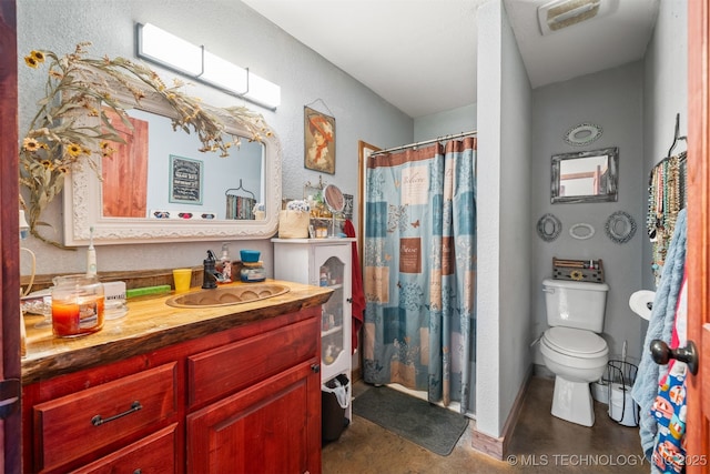 3819 129th Rd, Panola, OK 74559 - bathroom featuring vanity, toilet, finished concrete floors, a textured wall, and a shower with shower curtain