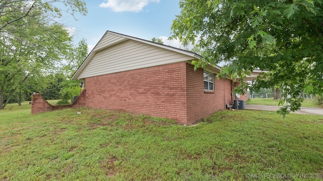 22112 W Coyote Trl Unit S, Sand Springs, OK 74063 - view of side of property featuring a lawn, cooling unit, concrete driveway, an attached carport, and brick siding