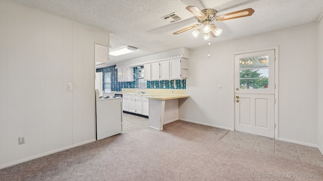 22112 W Coyote Trl Unit S, Sand Springs, OK 74063 - kitchen with a ceiling fan, white cabinetry, white range, a textured ceiling, and light countertops