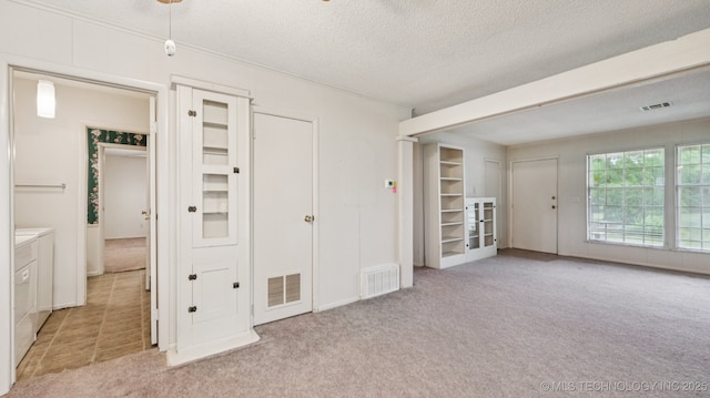 22112 W Coyote Trl Unit S, Sand Springs, OK 74063 - carpeted spare room with a textured ceiling and washing machine and dryer