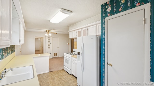 22112 W Coyote Trl Unit S, Sand Springs, OK 74063 - kitchen with white appliances, a sink, light countertops, white cabinetry, and ceiling fan