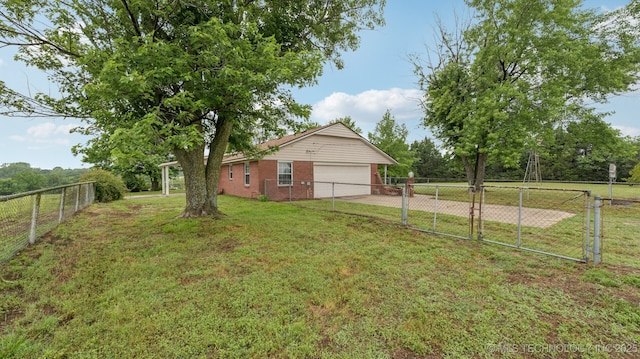 22112 W Coyote Trl Unit S, Sand Springs, OK 74063 - view of yard with a garage, concrete driveway, and a gate