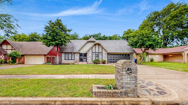 1120 N Juniper Pl, Broken Arrow, OK 74012 - tudor house with a garage, driveway, a front yard, and brick siding