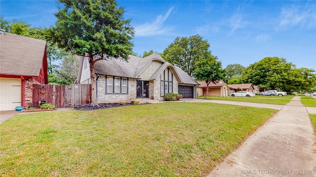 1120 N Juniper Pl, Broken Arrow, OK 74012 - tudor home featuring concrete driveway, brick siding, and an attached garage