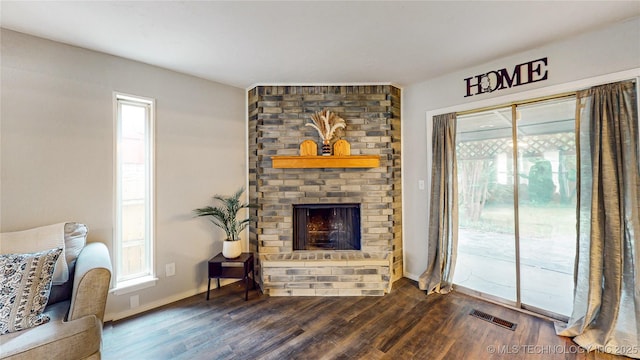 1120 N Juniper Pl, Broken Arrow, OK 74012 - living room featuring dark wood-style floors, a brick fireplace, and baseboards