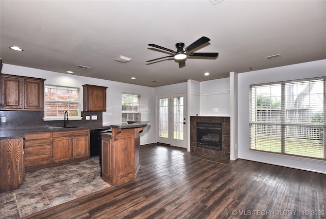 307 W K St, Jenks, OK 74037 - kitchen with a sink, dishwasher, a ceiling fan, dark countertops, and dark wood finished floors