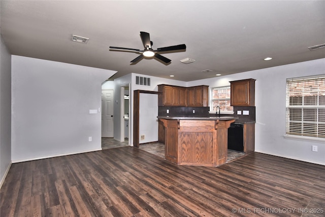 307 W K St, Jenks, OK 74037 - kitchen featuring dark wood finished floors, a ceiling fan, baseboards, a sink, and a kitchen island