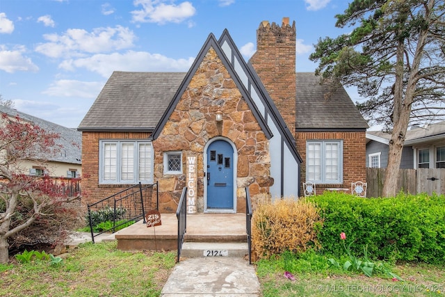 2124 E 19th St, Tulsa, OK 74104 - tudor house with a chimney, stone siding, and roof with shingles