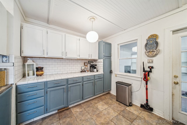 2124 E 19th St, Tulsa, OK 74104 - kitchen featuring tasteful backsplash, blue cabinets, white cabinetry, and decorative light fixtures