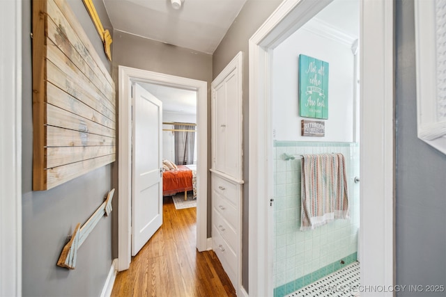 2124 E 19th St, Tulsa, OK 74104 - corridor with tile walls, wood finished floors, and a wainscoted wall