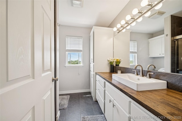 31102 S 4190th Rd, Inola, OK 74036 - bathroom featuring vanity, baseboards, a shower with shower door, and tile patterned flooring