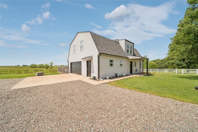 31102 S 4190th Rd, Inola, OK 74036 - view of side of home with driveway, a shingled roof, a garage, and a gambrel roof