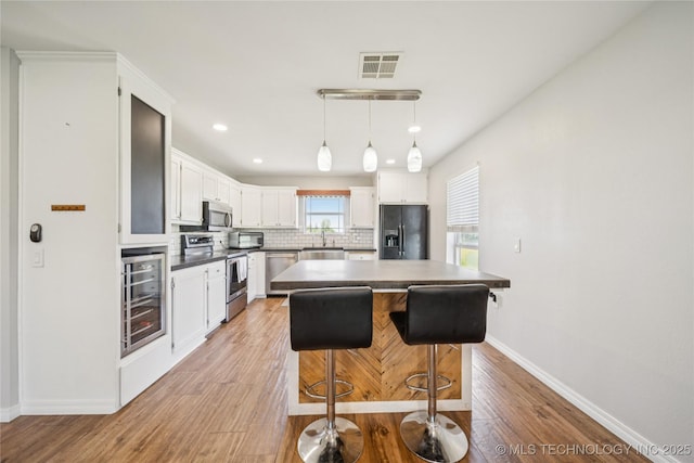 31102 S 4190th Rd, Inola, OK 74036 - kitchen featuring appliances with stainless steel finishes, beverage cooler, backsplash, baseboards, and recessed lighting